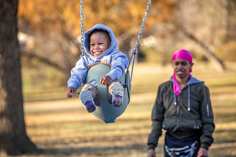 Taniece Blackman played with her 2-year-old son, Tyrell Glover, at the playground adjacent to Good Shepherd Children and Family Services in University City Nov. 19. Good Shepherd Children and Family Services is among the many pro-life organizations that work with pregnant and parenting families in the Archdiocese of St. Louis.