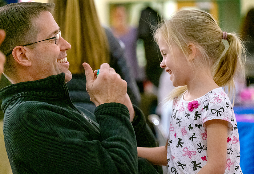 Father Christopher Martin, Pastor of St. Clare of Assisi Parish, visited with Hadley Guntli, 5, at the parish’s annual Family Advent Gathering on Dec. 1. The gathering included Advent trivia, Advent story time and a meal.