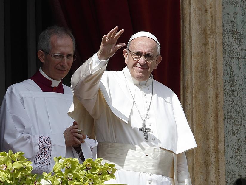 Pope Francis greeted the crowd after delivering his Easter blessing "urbi et orbi" (to the city and the world) from the central balcony of St. Peter's Basilica at the Vatican April 1. 