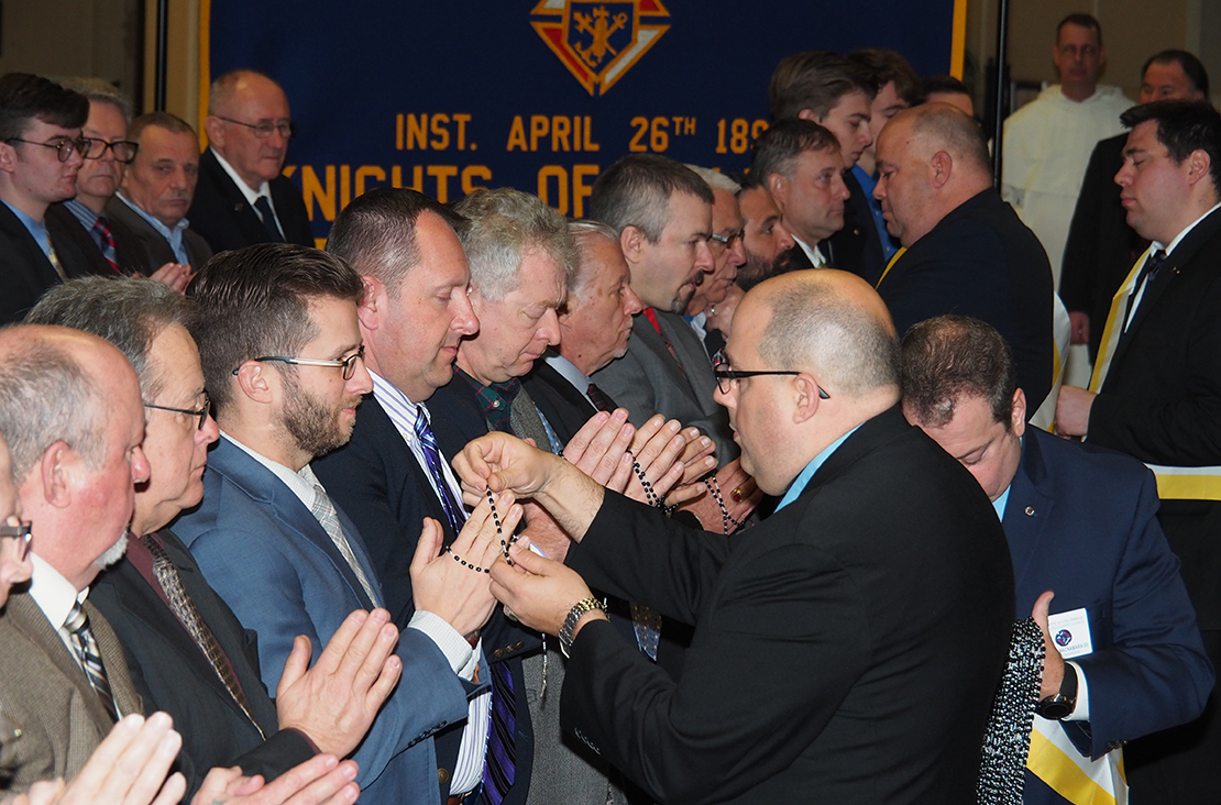 Members of the Knights of Columbus received rosaries Jan. 1, as part of the organization's new ceremony that is designed to condense the Knights of Columbus' three degrees into one. In addition, the ceremony is now conducted in public instead of in a secret, members-only occasion.