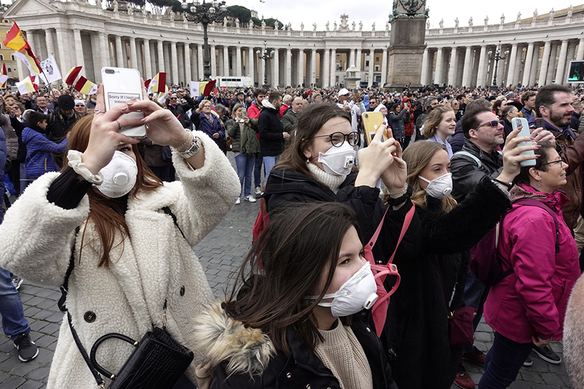 People wore masks for protection from the coronavirus while attending the Angelus led by Pope Francis at St. Peter’s Square at the Vatican March 1. In spite of many health organizations saying that masks don't provide sufficient protection against the virus, many people choose to wear them.