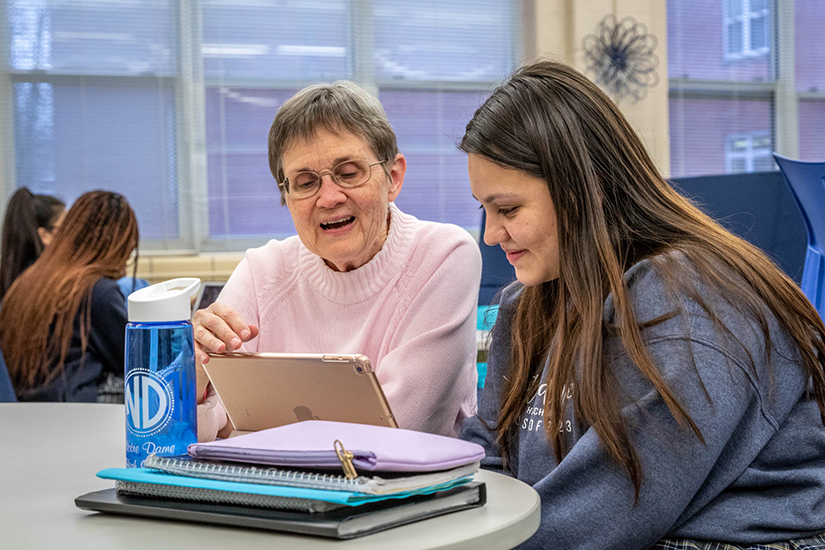 Sister Paulette Zimmerman, SSND, worked with Juliana Gervacio at Notre Dame High School in Lemay Feb. 24. The two are part of a pilot program that is an outgrowth of the English Tutoring Project assisting English language learners in grade schools.