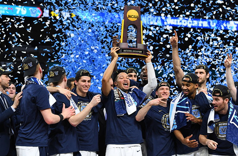 Villanova Wildcats guard Jalen Brunson hoists the national championship trophy after defeating the Michigan Wolverines, 79-62, in the 2018 NCAA men’s basketball championship April 2 in San Antonio.