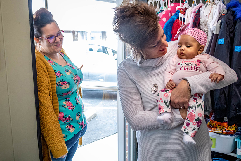 Sue Cooke, right, held Lillian Potter while helping mom Lauren at Mary Queen of Angels pregnancy resource center in O’Fallon March 2. Mary Queen of Angels serves about 500 moms, with a team of about 20 volunteers.