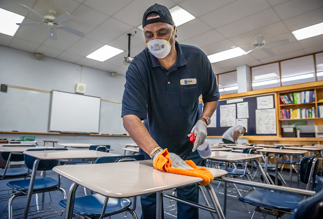 Alvin Poe cleaned a classroom at Bishop DuBourg High School in St. Louis on March 18.