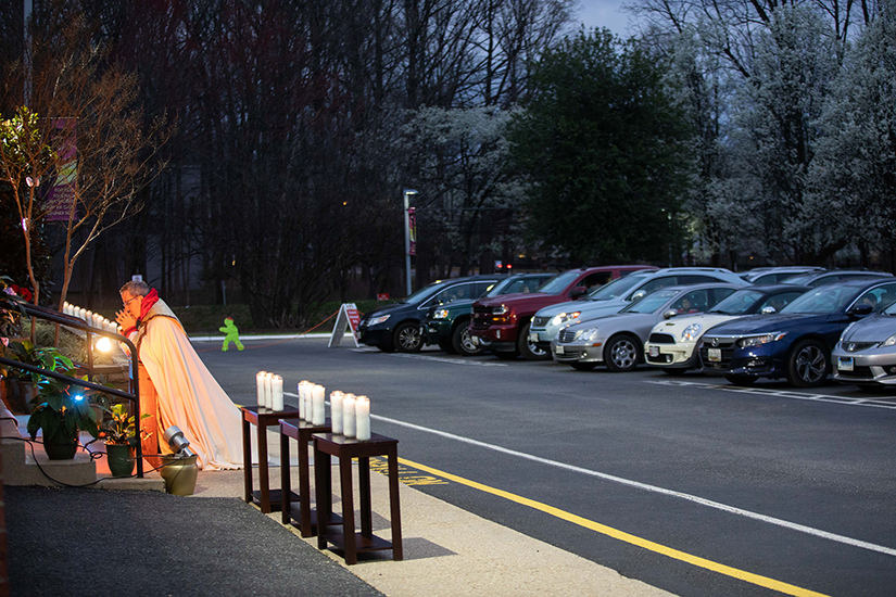 Father Dan Leary of St. Andrew Apostle Parish in Silver Spring, Maryland, led prayers for eucharistic adoration March 21 as parishioners remained in their cars.
