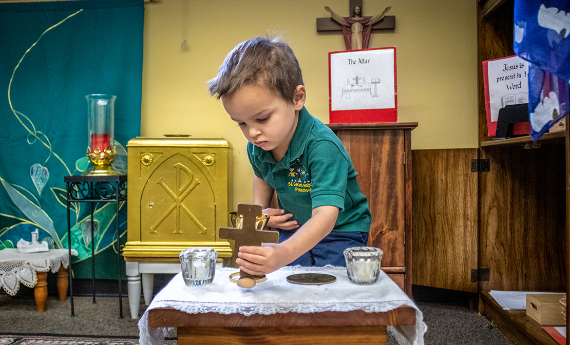 Preschool student Declan Vaughn set up an altar in the Catechesis of the Good Shepherd Atrium at St. Gerard Majella in Kirkwood. Catechesis of the God Shepherd is a religious program designed to nurture children in their faith and to develop a relationship with the Lord.