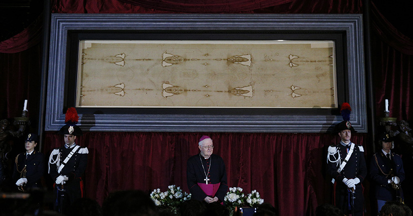Archbishop Cesare Nosiglia of Turin, papal custodian of the Shroud of Turin, stood in front of the shroud during a preview for journalists in the Cathedral of St. John the Baptist in Turin, Italy, in 2015 before a previous exposition of the shroud.