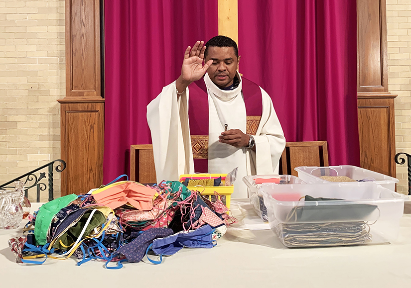 Father Javier Julio, associate pastor at St. Mary’s Catholic Church in Shrewsbury, Mass., blessed face masks made by a parish ministry of 30 people March 28. Father Julio is one of the priests trained as a minister to the sick amid the coronavirus (COVID-19) pandemic.