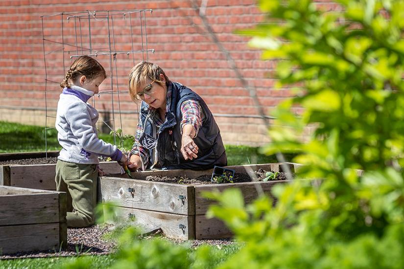 Jamie Hasemeier planted seeds and seedlings with the help of her daughter, Ruby, a first-grader at Holy Redeemer School in Webster Groves, May 6. Hasemeier urges further action within the Catholic Church to “take the next step along the process of caring for creation, wherever that step may be.”