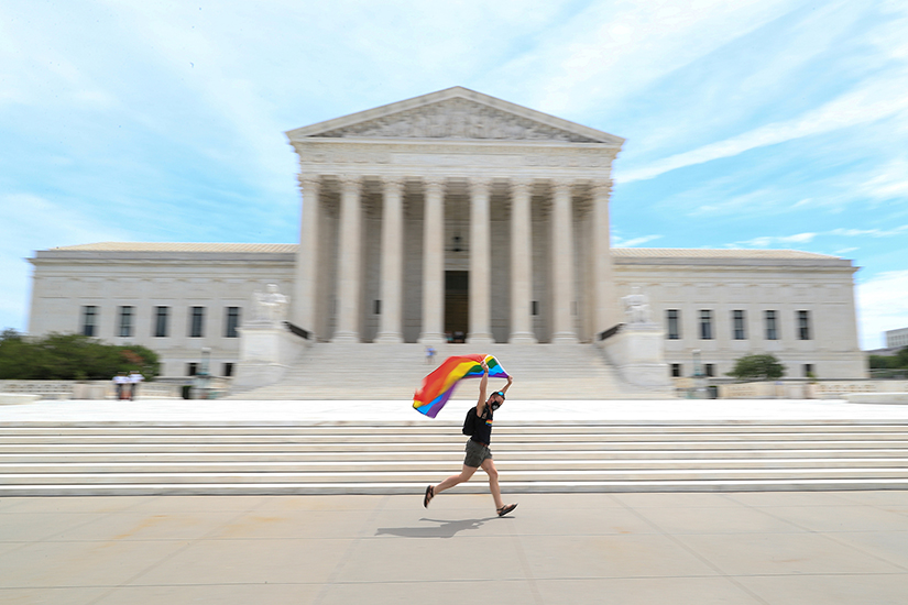 A person celebrated in front of the U.S. Supreme Court building in Washington June 15. In a 6-3 vote that same day, the Supreme Court said LGBT people are protected from job discrimination by Title VII of the Civil Rights Act of 1964.