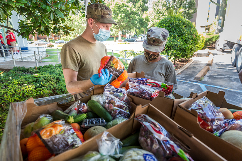 Specialists Jason Arden and Saricia Murrey of the Missouri National Guard stocked perishables as Catholic Charities distributed food and personal care items at Catholic Charities headquarters in St. Louis on July 24. Nearly 500 households were assisted during the distribution.