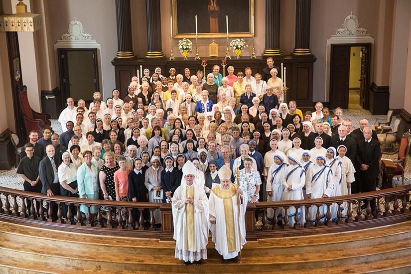 Archbishop Robert J. Carlson and then-Auxiliary Bishop Edward M. Rice posed for a picture with men and women religious after a Mass celebrating consecrated life in 2014, the 250th anniversary of the founding of St. Louis.