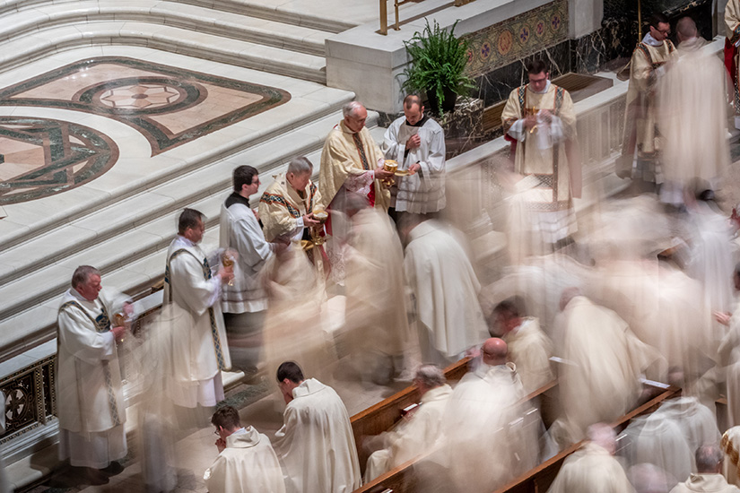 Archbishop Robert J. Carlson distributed the Eucharist to priests of the archdiocese at the Chrism Mass at the Cathedral Basilica of Saint Louis in 2019.