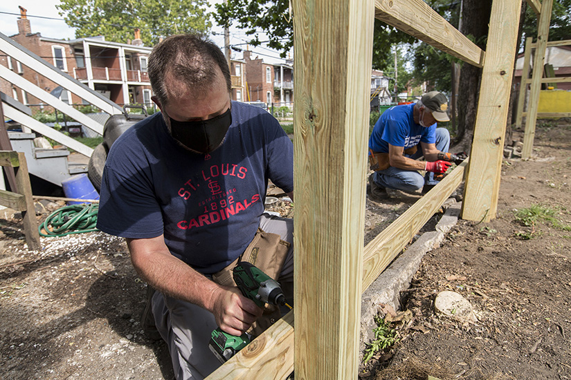 Gary Nipper, left, with St. Stephen the Protomartyr Parish’s Holy Name Society, and Ron Decker with First Presbyterian Church of Kirkwood, joined other workers organized by St. Joseph Housing Initiative to construct a backyard fence Saturday at a house in the Dutchtown neighborhood of St. Louis on Aug. 29.