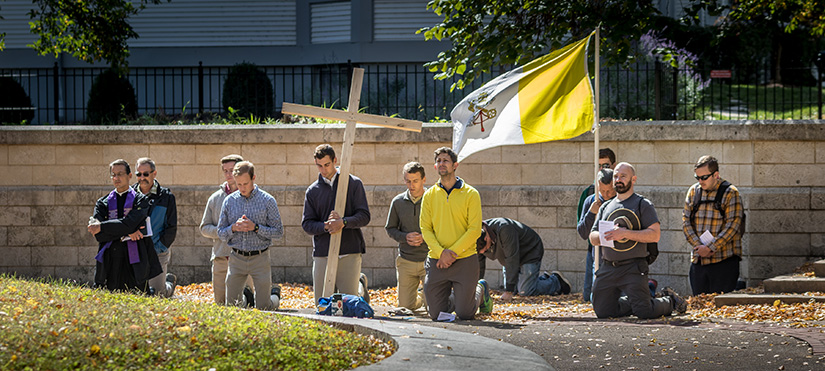 Pilgrims in the Joseph Challenge knelt in prayer after they arrived at their final destination at the Shrine of St. Joseph Downtown on Oct. 4. The men walked 24 miles from St. Joseph Church in Manchester to the shrine, taking time for prayer, reflection and fellowship along the way.