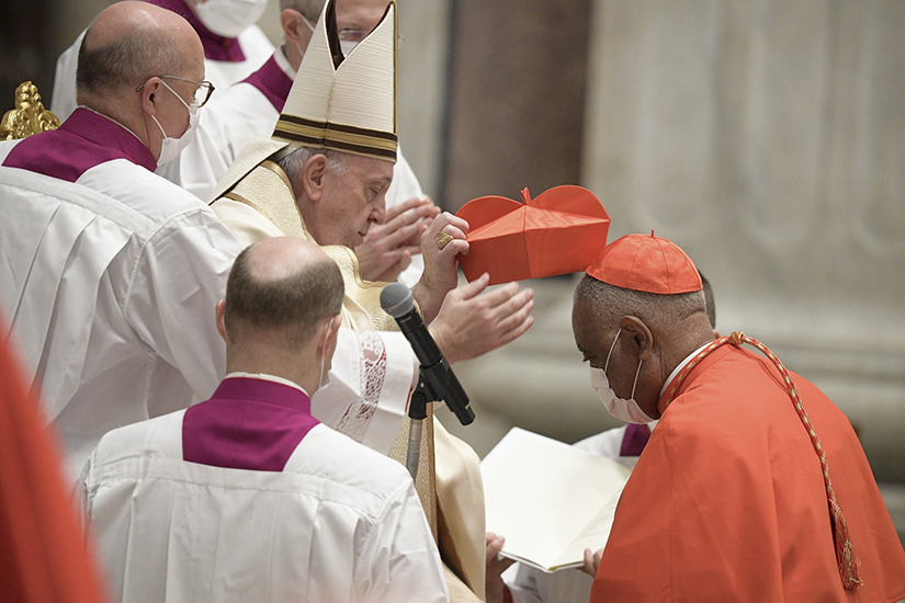 Pope Francis placed the red biretta on new Cardinal Wilton D. Gregory of Washington during a consistory for the creation of 13 new cardinals in St. Peter’s Basilica at the Vatican Nov. 28.