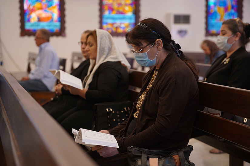 A woman prayed at Mass at a church in Mosul, Iraq, Nov. 1. The Vatican has confirmed Pope Francis will visit Iraq March 5-8, barring obstacles caused by the COVID-19 pandemic.