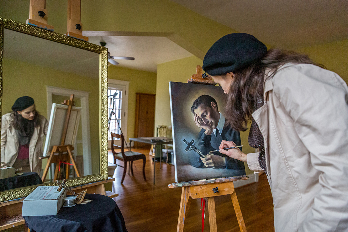 Gwyneth Thompson-Briggs worked on a painting of St. Gerard Majella in her studio in St. Louis Dec. 12. Thompson-Briggs said that “we need visible and audible beauty to help us see the glory of God.”