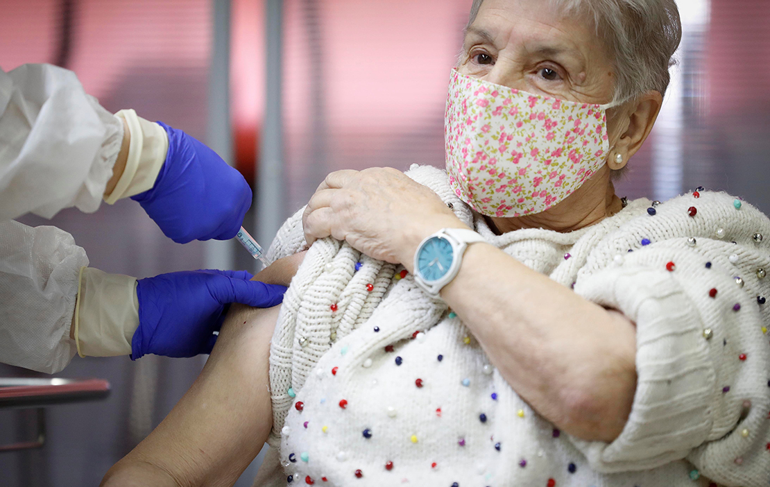 An elderly woman received an injection with a dose of Pfizer-BioNTech COVID-19 vaccine at Vallecas nursing home in Madrid Dec. 27.