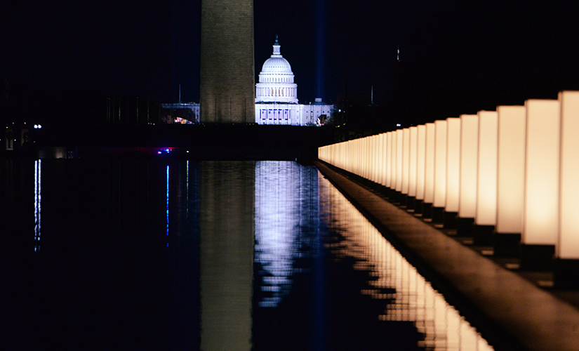 The U.S. Capitol is seen reflected at the reflecting pool at the Lincoln Memorial in Washington Jan. 19 after President-elect Joe Biden hosted a memorial honoring those who died from the coronavirus disease. Cardinal Wilton Gregory of Washington, D.C., prayed at the memorial.