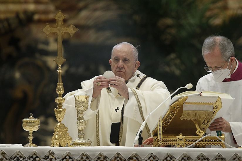Pope Francis elevated the Eucharist as he celebrated Mass on the feast of the Epiphany in St. Peter’s Basilica at the Vatican Jan. 6.
