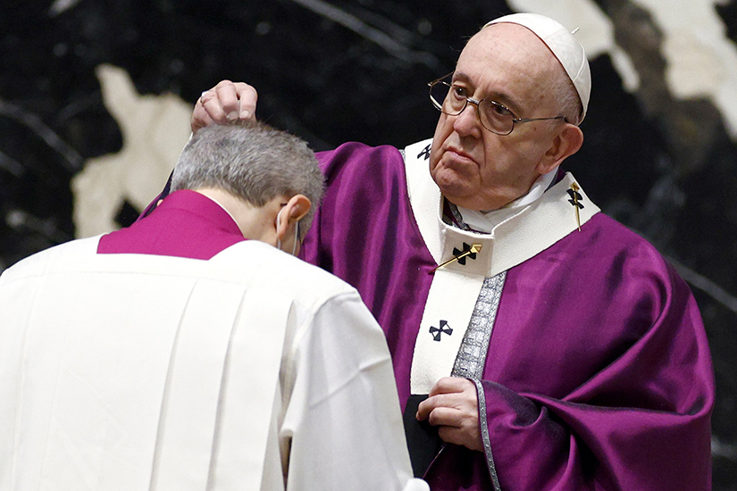 Pope Francis sprinkled ashes on the head of a priest at Ash Wednesday Mass in St. Peter’s Basilica at the Vatican Feb. 17.