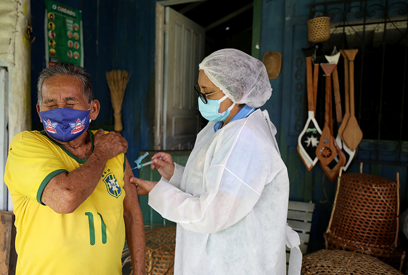 An Indigenous man received the AstraZeneca/Oxford COVID-19 vaccine from a municipal health worker in the Sustainable Development Reserve of Tupe in Manaus, Brazil, Feb. 9.