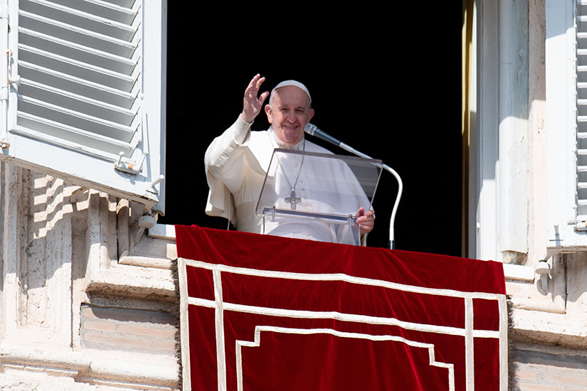 Pope Francis greeted the crowd as he led the Angelus from the window of his studio overlooking St. Peter’s Square at the Vatican Feb. 21. Pope Francis said that faith, prayer and penance are weapons Christians are given to overcome temptations from the devil.