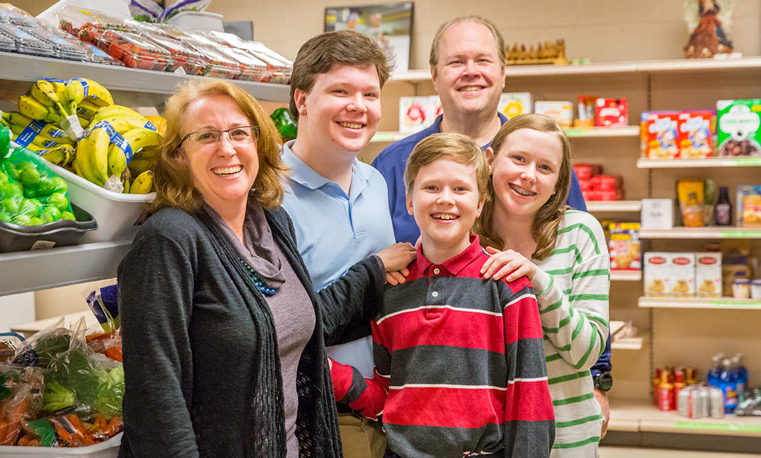 Volunteering at the Affton Christian Food Pantry is among the ways the Meehans, live faith as a family. From left: Jen, James, Patrick, Jim and Megan.