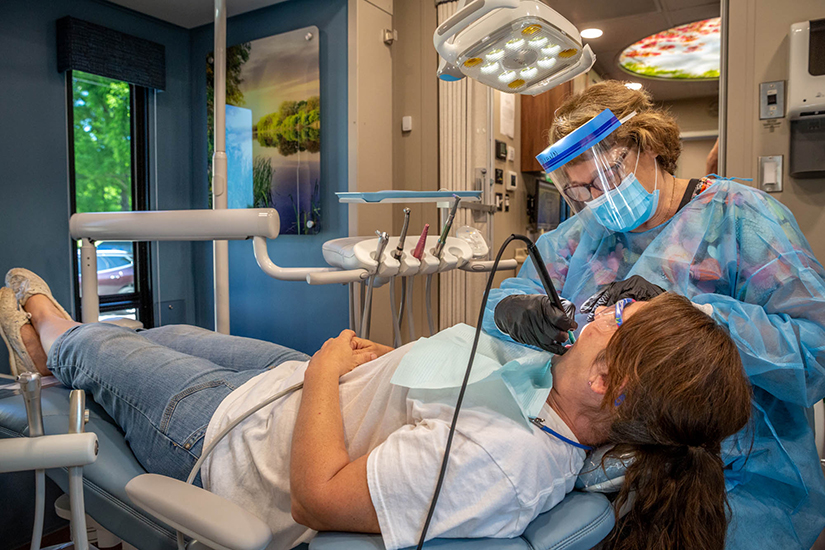 Dental hygienist Diann Bomkamp acknowledges that her patients often have a real fear of the dentist, “I do anything I can do make it more comfortable,” she said. She cleaned Kim Estes’ teeth at the Rural Parish Clinic-Dental at St. Joachim Parish in Old Mines on June 11.