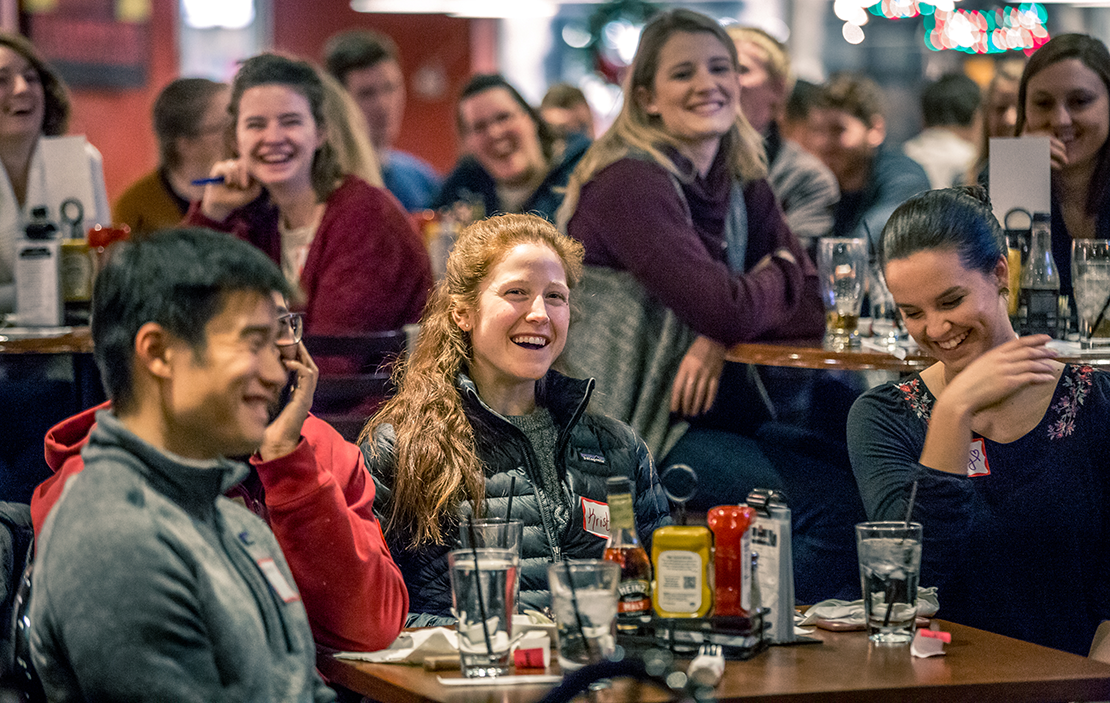 Kristen DeLaune, center, laughed with friends during Father Eddie Voltz's Theology on Tap talk at Kirkwood Station Brewing. Theology on Tap is held monthly, giving young adults a chance to meet, socialize and learn about topics relevant to young adult Catholics.