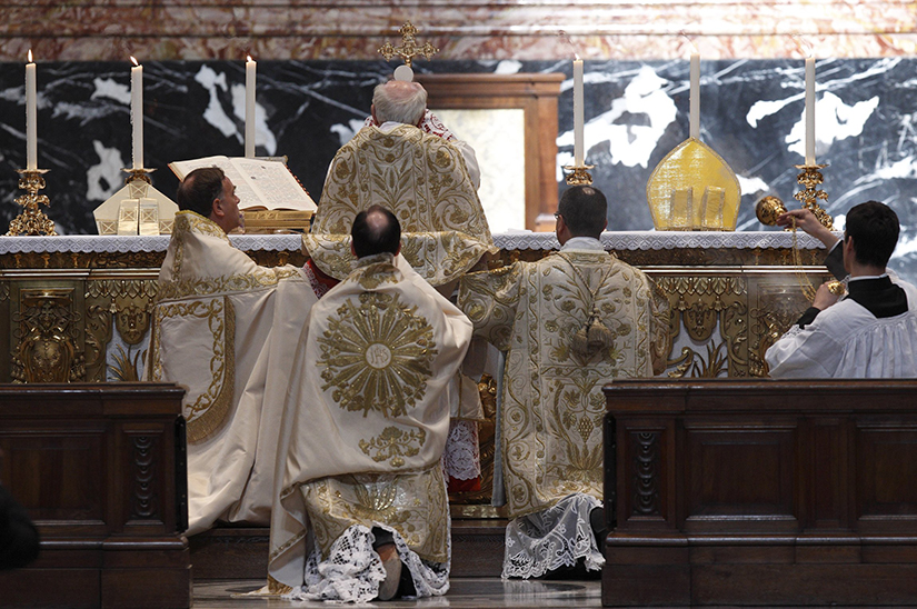 Cardinal Walter Brandmuller elevates the Eucharist during a Tridentine-rite Mass at the Altar of the Chair in St. Peter's Basilica at the Vatican in 2011.