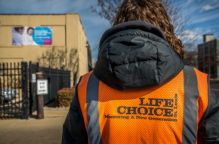 Coalition for Life intern Katie Gossar waits to talk to women as they arrive at Planned Parenthood on March 13. The St. Louis Board of Aldermen rejected a bill that would have created a buffer zone around health care facilities, including Planned Parenthood.
