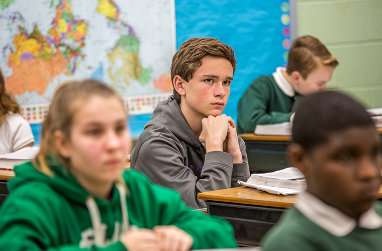 Jackson Cooper, a seventh-grader at Christ the King School in University City, listened to teacher Mike Bettonville in social studies class on April 16. Jackson is the Missouri state winner of the National Geographic Bee and will head to Washington, D.C., to compete with 53 other winners from across the United States.