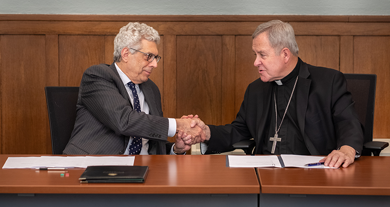 St. Louis University president Fred Pestello, left, and Archbishop Robert J. Carlson signed an agreement that will confer undergraduate degrees from SLU to the graduates of Cardinal Glennon College, although they will still study at Kenrick-Glennon Seminary. The agreement was signed April 23 in the Kenrick Board Room at the Cardinal Rigali Center in Shrewsbury.