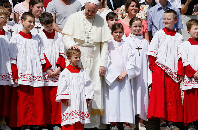 Pope Francis greeted altar servers at his general audience April 25 in St. Peter’s Square at the Vatican. In his talk, the pope said, “Baptism is not a magic spell but a gift of the Holy Spirit that allows those who receive it to fight against the spirit of evil.”