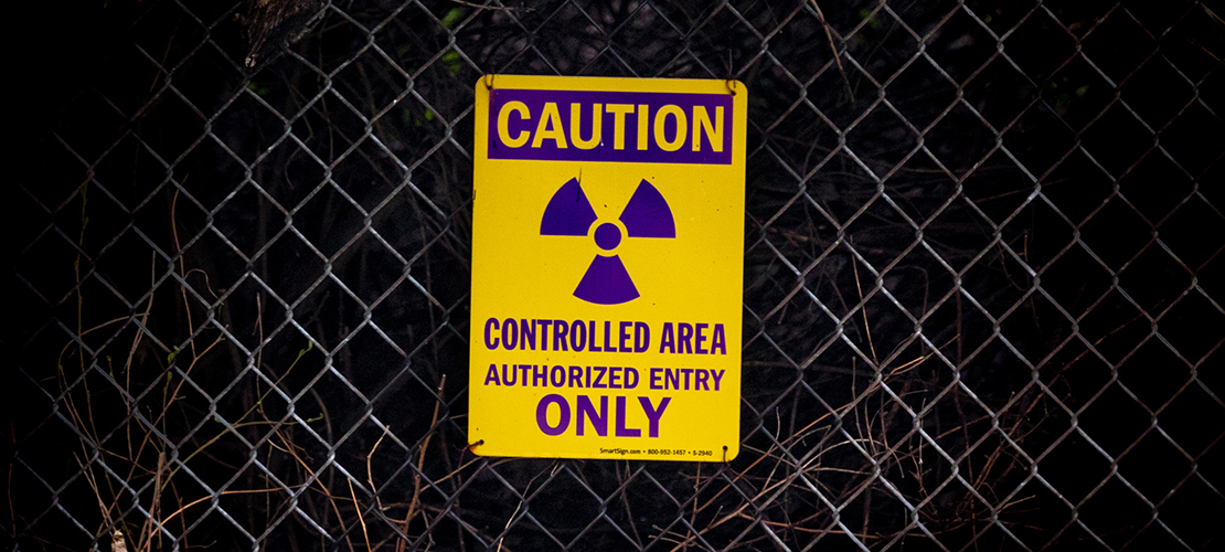 A sign hanging on a chain-link fence at St. Charles Rock Road warns of the radioactive waste contained at West Lake Landfill Superfund Site.