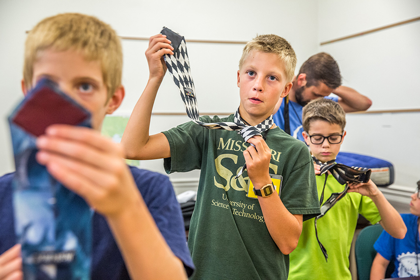 Daniel Goring, from St. Paul Church in Highland, Ill., learned
how to put on tie as part of a session entitled “How to be a man” at Kenrick-Glennon Days. The session also included tips for shaving and the importance of a firm handshake.