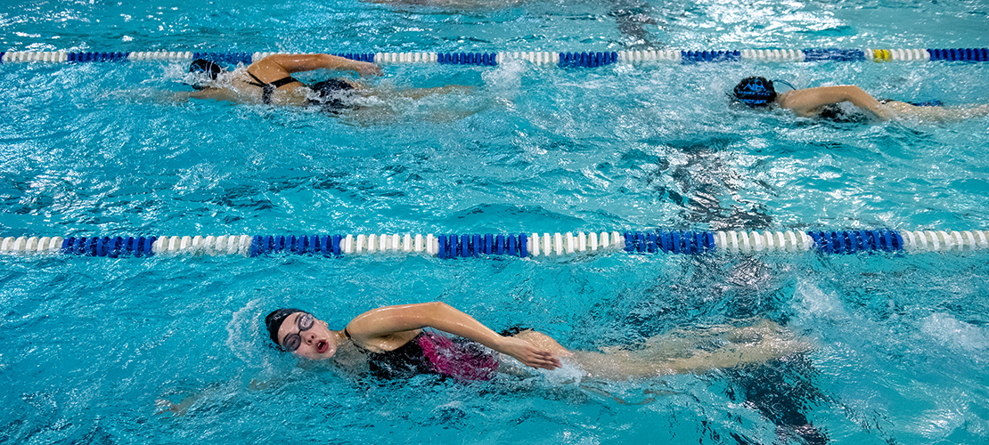 Nerinx Hall swimmers work as a powerful unit
