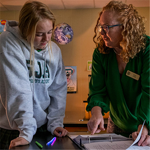 St. Joseph’s Academy teacher Katie Lodes helps her students move from thinking to action