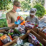 Catholic Charities assists a community in need through distribution of care packages