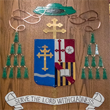 Retired woodworker Bill Kennebeck has enjoyed making several coats of arms for local bishops