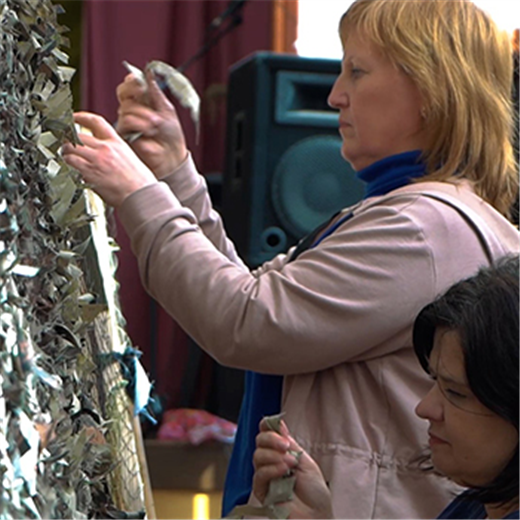 Volunteers weave fellowship, and camouflage nets, in Ukrainian church
