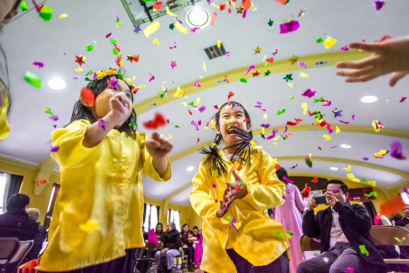 Vy Nguyen, age 5, and Patricia Duong, 6, played with confetti at a celebration of Vietnamese New Year. The community at Resurrection of Our Lord Parish in south St. Louis celebrated the Lunar New Year on Feb. 11. The official New Year began Feb. 16.