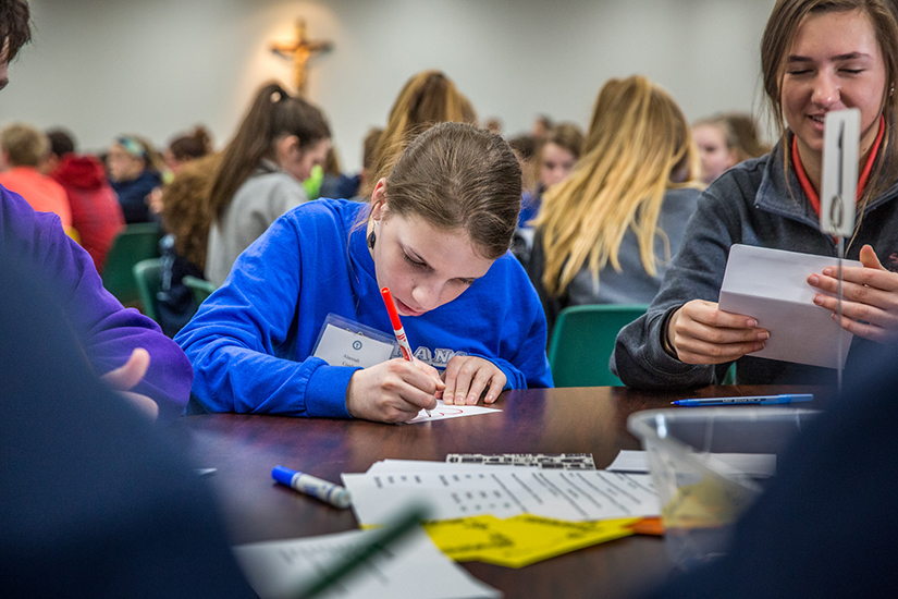 Alannah Coady, from St. Francis of Assisi School, created a card of hope for a homeless person during a service project
with other Catholic schools on Feb. 27. Eighth-graders from Region 5 Catholic schools gathered at St. Simon the Apostle to
celebrate Mass with Bishop Mark Rivituso. After Mass, they did a service project for St. Patrick Center.