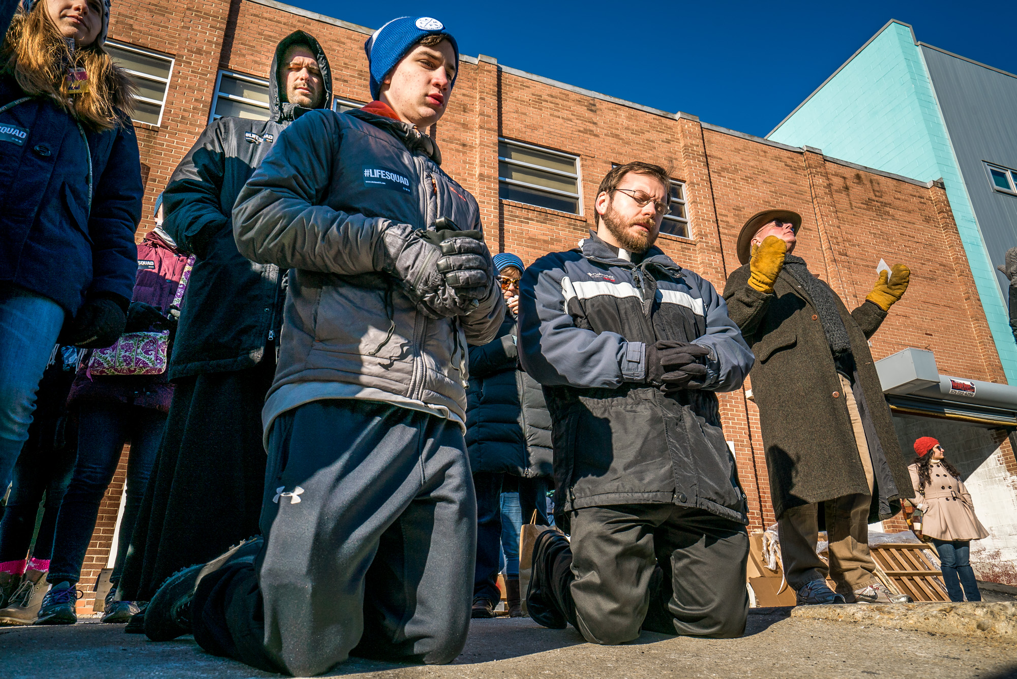 From left, Father James Adams, Jame Pierucci, Father Tom McNally and Mike Caldwell from Kalamazoo, Mich., prayed outside of Planned Parenthood Jan. 18 in Washington, D.C. The group was participating in a protest outside the clinic held by Priests for Life.