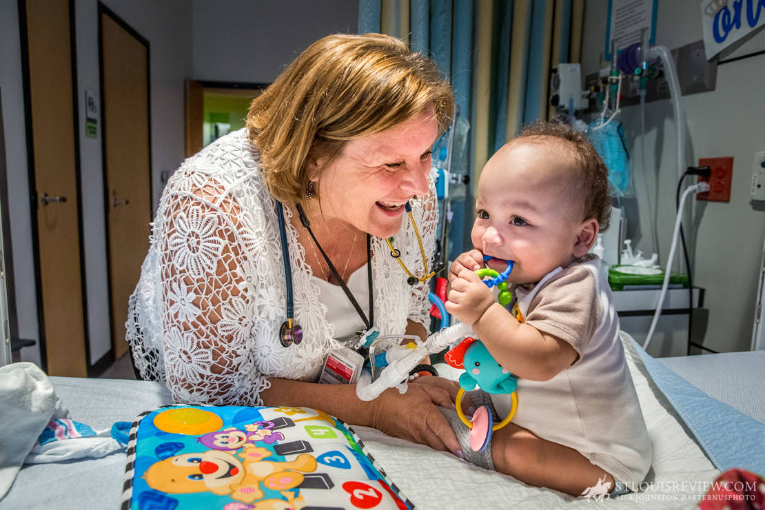 Karen Sepe visited with her patient, 13-month-old Jacobi, in a patient room at Ranken Jordan Pediatric Bridge Hospital on June 26. Sepe recently spoke at St. Cletus Parish on the link between science and faith thanks to a grant to ITEST. Sepe said that a continuing education class in which she was able to hold a human brain overwhelmed her with the complexity of God’s creation.