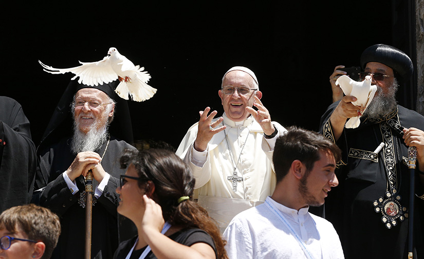 Pope Francis and Pope Tawadros II of Alexandria, patriarch of the Coptic Orthodox Church, right, released doves as they stood with Ecumenical Patriarch Bartholomew of Constantinople July 7 outside the Basilica of St. Nicholas in Bari, Italy. The pope was meeting with Christian leaders for an ecumenical day of prayer for peace in the Middle East.