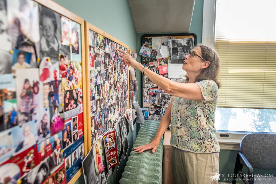 Mary Ann Hoeynck is retiring as the adoption coordinator for Good Shepherd Children and Family Services after 40 years of service to the Catholic Charities agencies that combined to form Good Shepherd. Her office includes photographs of families and children she has helped over the years.